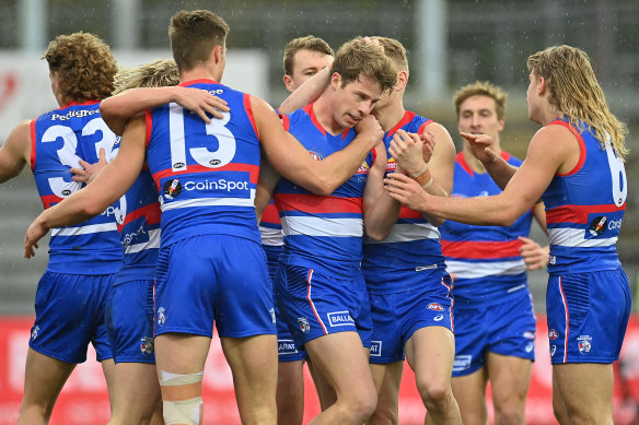 Mitch Hannan is congratulated by his teammates.