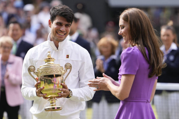 Carlos Alcaraz smiles after receiving his trophy from the Princess of Wales.