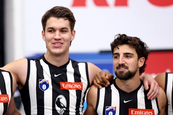 Charlie West and Josh Daicos of the Magpies sing the song in the rooms.