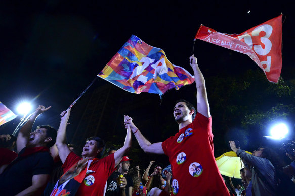 Supporters of candidate Luiz Inácio Lula da Silva of Workers’ Party react to the vote count.