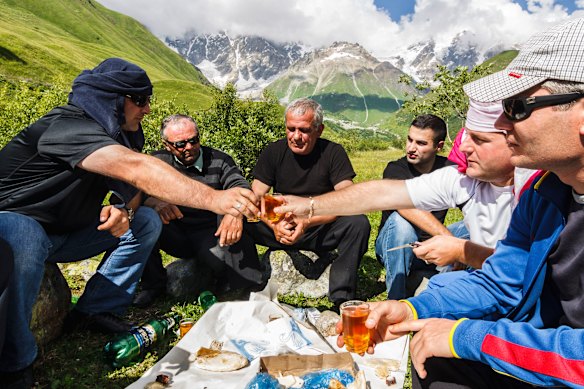 Locals toast during a traditional Georgian “supra” feast in the Svaneti region.
