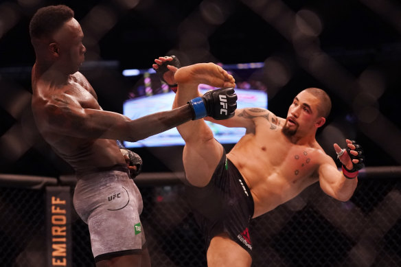 Robert Whittaker, right, and Israel Adesanya, left, trade blows during UFC 243.