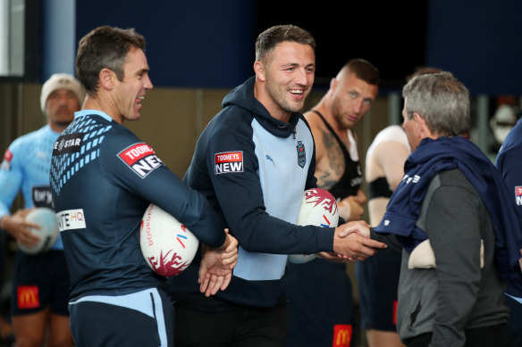 Sam Burgess greets Penrith great Royce Simmons alongside NSW coach Brad Fittler.