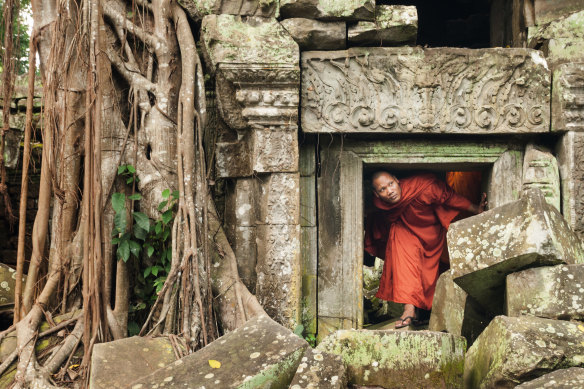 Visit Ta Phrom at sunrise when tour groups head to Angkor Wat.