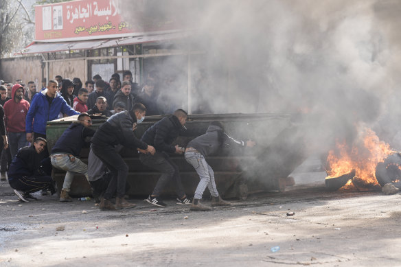 Palestinians clash with Israeli forces following an army raid in the West Bank city of Jenin on Thursday.