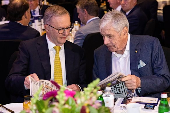 Kerry Stokes shows a copy of The West Australian to Anthony Albanese in 2022.
