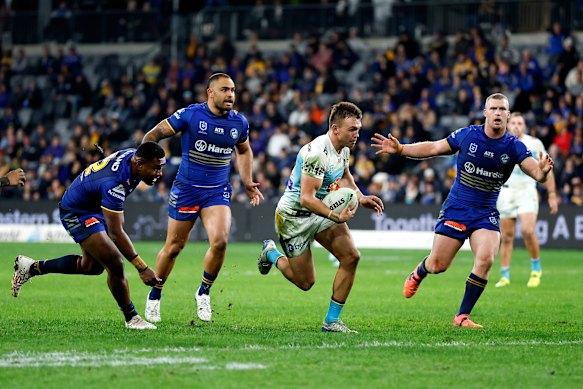 Chris Randall makes a break for Gold Coast against Parramatta.
