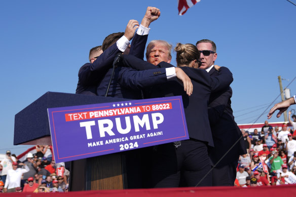 Former president Donald Trump is surrounded by Secret Service agents at a campaign rally in Pennsylvania.