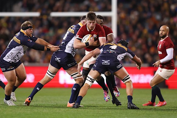 Joe McCarthy of British & Irish Lions is tackled by Lachlan Shaw.
