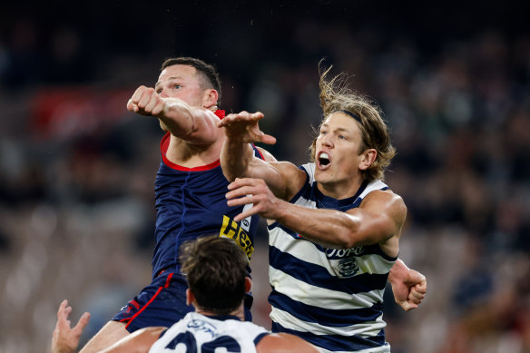 Steven May of the Demons and Rhys Stanley of the Cats compete for the ball.