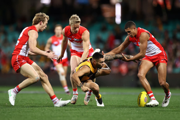 Jarman Impey is tackled against the Swans.