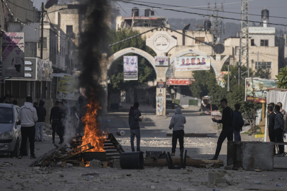 Palestinians clash with Israeli forces following an army raid in the West Bank city of Jenin on Thursday.