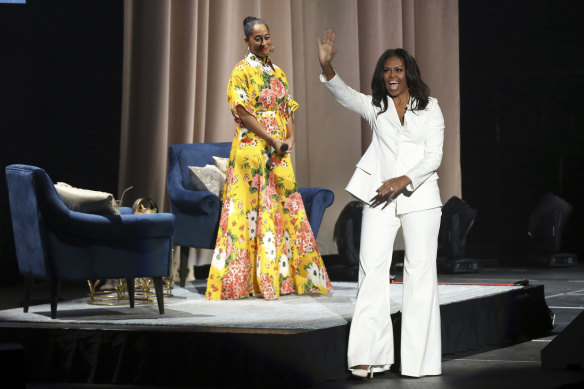 Former first lady Michelle Obama and Tracee Ellis Ross in California during her 2018 'Becoming' book tour. Michelle wore a custom Christian Siriano suit .