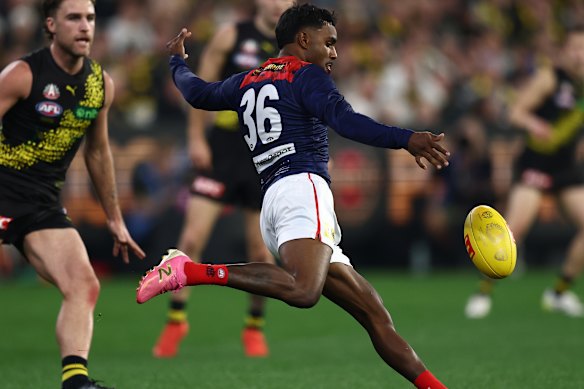 Kysaiah Pickett of the Demons kicks the ball.