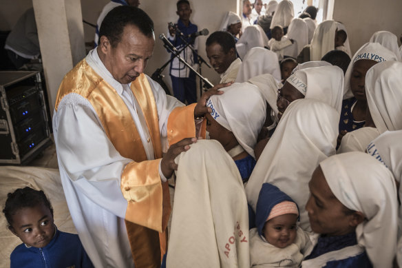 Andre Christian Dieudonne Mailhol, the founder of the Church of the Apocalypse, with followers in Ankazobe, Madagascar, in late May 2019.