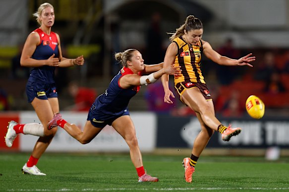 Laura Stone of the Hawks is tackled by Tyla Hanks of the Demons.