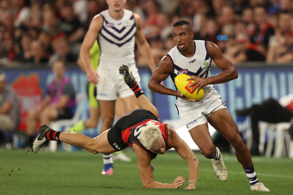 Brandon Walker evades Essendon’s Matt Guelfi.