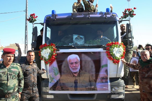 Mourners take part in a funeral procession for al-Muhandis in Basra, Iraq.