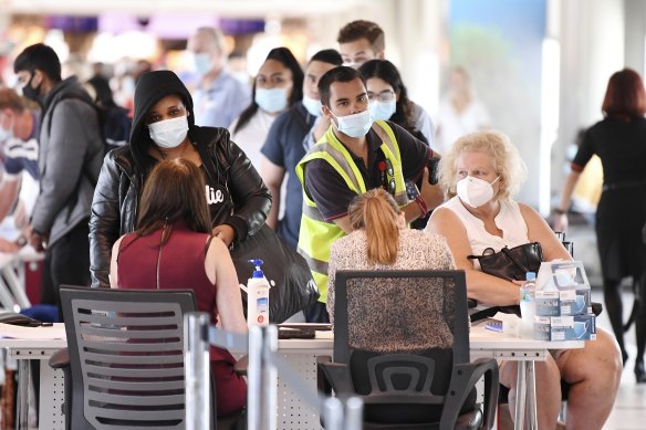 Incoming passengers are screened by police as they arrive at the domestic terminal at Brisbane Airport.