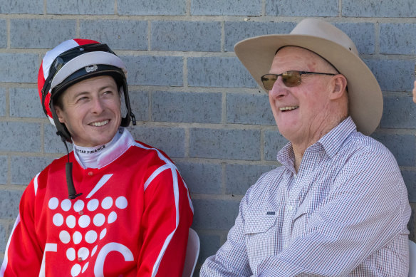 Harry Coffey talks with his dad, Austy, at the Echuca races on Sunday.