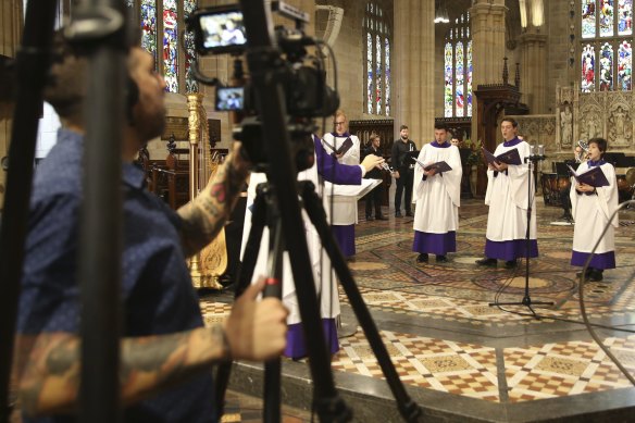 Members of St Andrew's Cathedral  choir record their Christmas service, which will be now be an online event because of the restrictions relating to COVID-19.