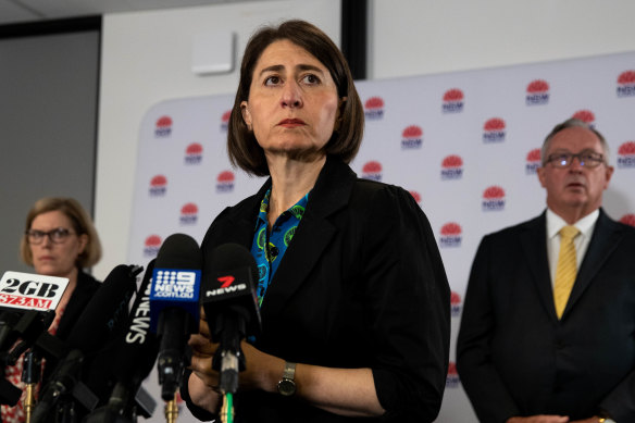 NSW Premier Gladys Berejiklian, flanked by Chief Health Officer Kerry Chant and Health Minister Brad Hazzard, at a press conference on Friday.