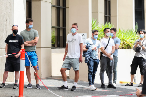 People associated with the Australian Open are seen lining up at a testing facility 