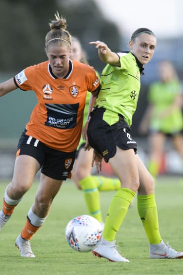 Natalie Tathem of Brisbane (left) and Olivia Price of Canberra (right) battle it out.