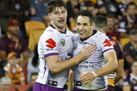 Billy Slater celebrates with teammates after scoring against Brisbane in round seven.