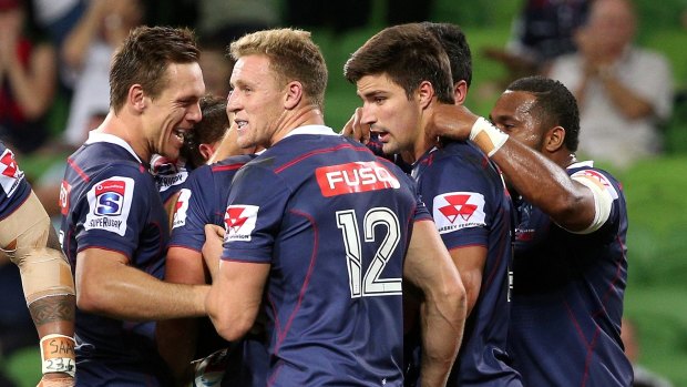 Big win: The Rebels celebrate a try against the Queensland Reds.