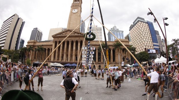 The Oktoberpole is raised during a two-hour process in the heart of Brisbane.