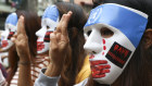 Young demonstrators flash the three-fingered symbol of resistance during an anti-coup mask strike in Yangon at the weekend. Pressure is mounting on companies with investments in the strife-torn country.