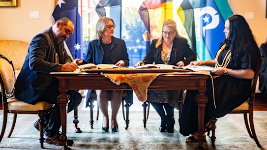 From right to left: First Peoples’ Assembly co-chair Rueben Berg, Premier Jacinta Allan, Minister for Treaty Natalie Hutchinson and assembly co-chair Ngarra Murray sign Victoria’s statewide treaty at Government House.