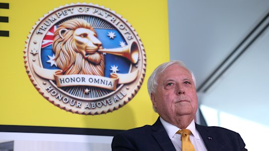 Clive Palmer stands before the insignia for his new party on Wednesday.