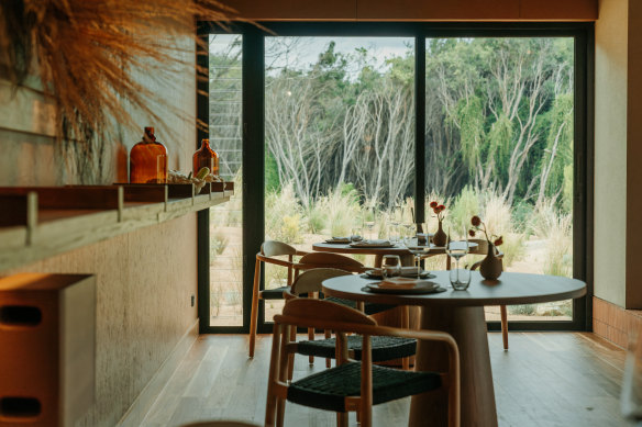 The dining room looks out to native vegetation and the kitchen garden.