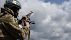 A Ukrainian serviceman shoots towards a drone in Zaporizhzhia.