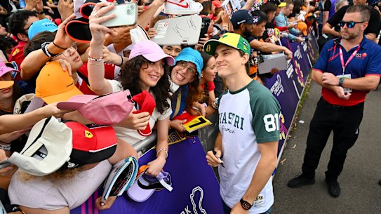 Oscar Piastri greets fans at Albert Park - it can be a rush to land a spot by the fence.
