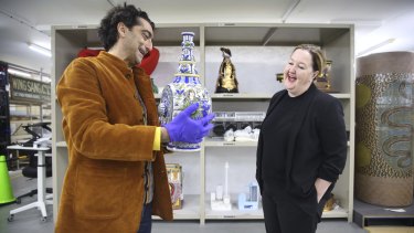 Professor Pedram Khosronejad inspects classical Islamic artefacts with Lisa Havilah in the basement of the Powerhouse Museum.