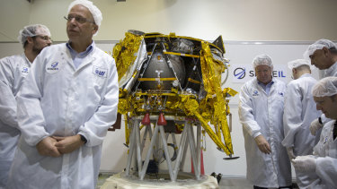 Israeli technicians stand next to the SpaceIL lunar module during a press tour of their facility near Tel Aviv last December.
