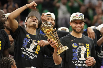 Golden State Warriors guard Stephen Curry holds up the Bill Russell Trophy after being named MVP. 
