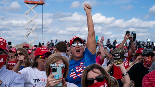 Supporters of President Donald Trump cheer as he arrives to speak at a campaign rally at Pitt-Greenville Airport in Greenville, NC. 
