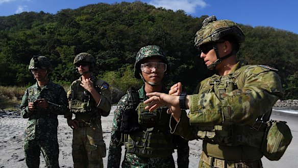 Australian Army Sapper Nicholas Field explains the timing procedure of a controlled explosion.