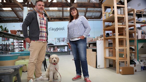 Brett Stone and Cherie Peyton, and dog Benton, at his studio. 
