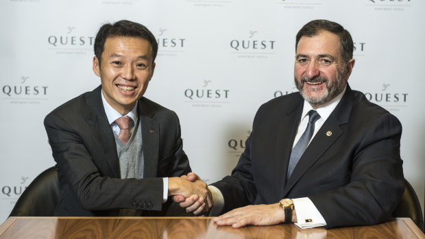Quest's Paul Constantinou shaking hands with Ascott's Lee Chee Koon after the sale of Quest.