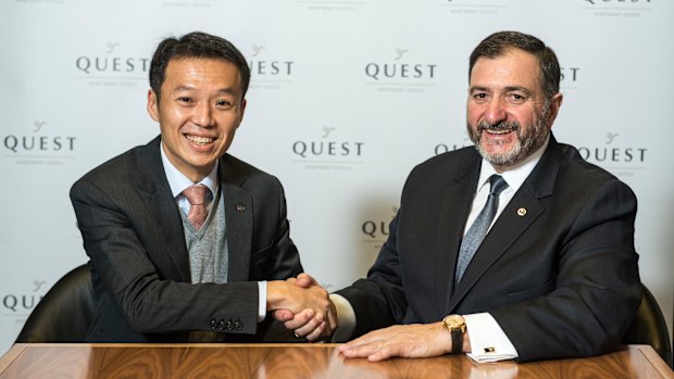 Quest's Paul Constantinou shaking hands with Ascott's Lee Chee Koon after the sale of Quest.