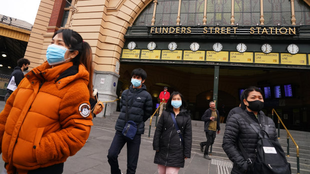 People leave Flinders Street Station on Sunday.