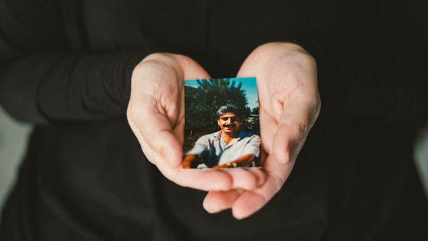 Mariya Tueter holds a photo of her late husband, one of Niels Hoegel's many victims.