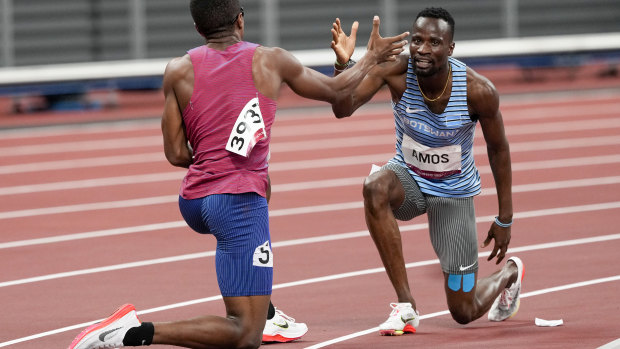 Isaiah Jewett and Nigel Amos help each other up after falling in their 800m semi-final.