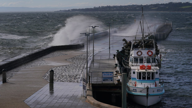 A large wave crashes over the harbour pier in Mornington on Thursday.
