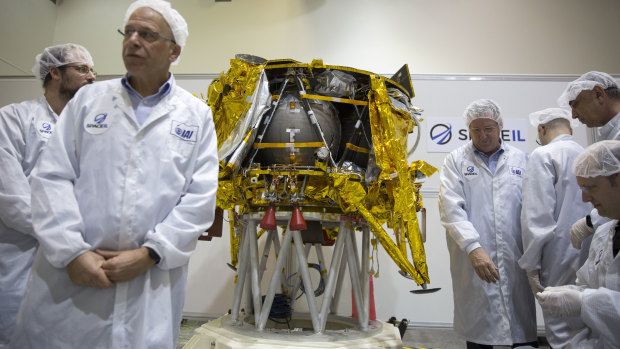 Israeli technicians stand next to the SpaceIL lunar module during a press tour of their facility near Tel Aviv last December.